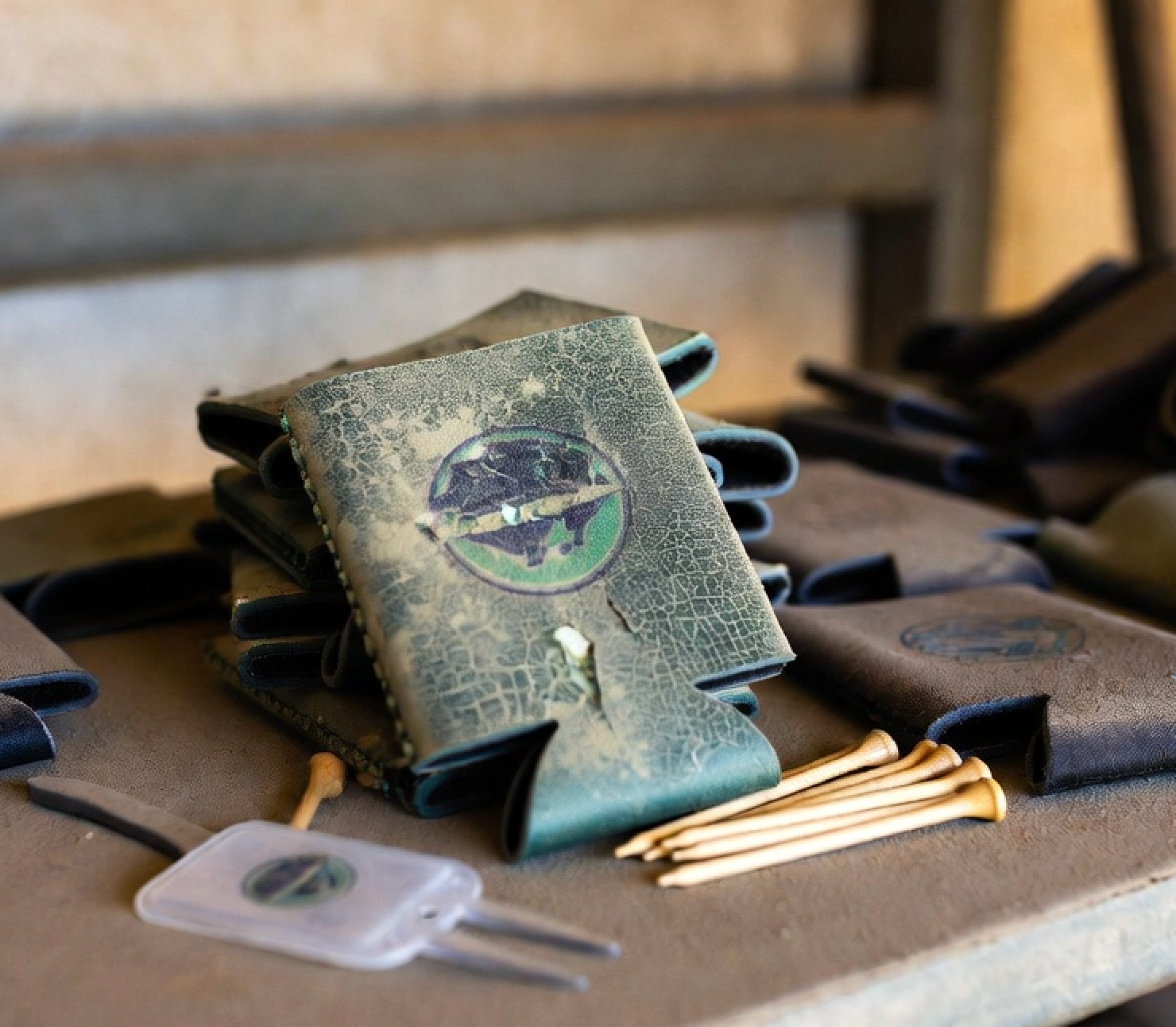 Pile of forgotten golf tournament swag and logo'd koozies on a garage shelf